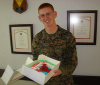 A Lance Corporal celebrates with personalized cake sent by his parents